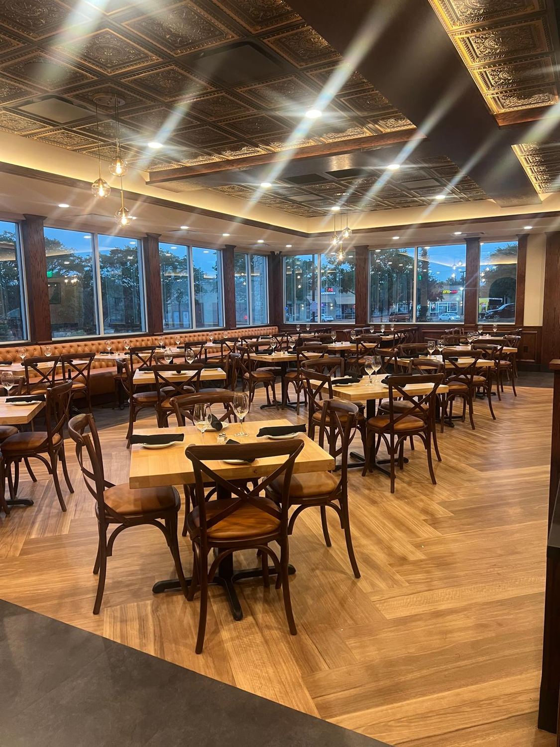 Wide view of the finished dining room with a window wall and wood flooring