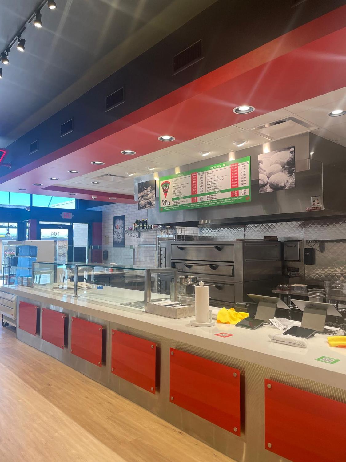 Finished serving line with red front panels and menu boards above