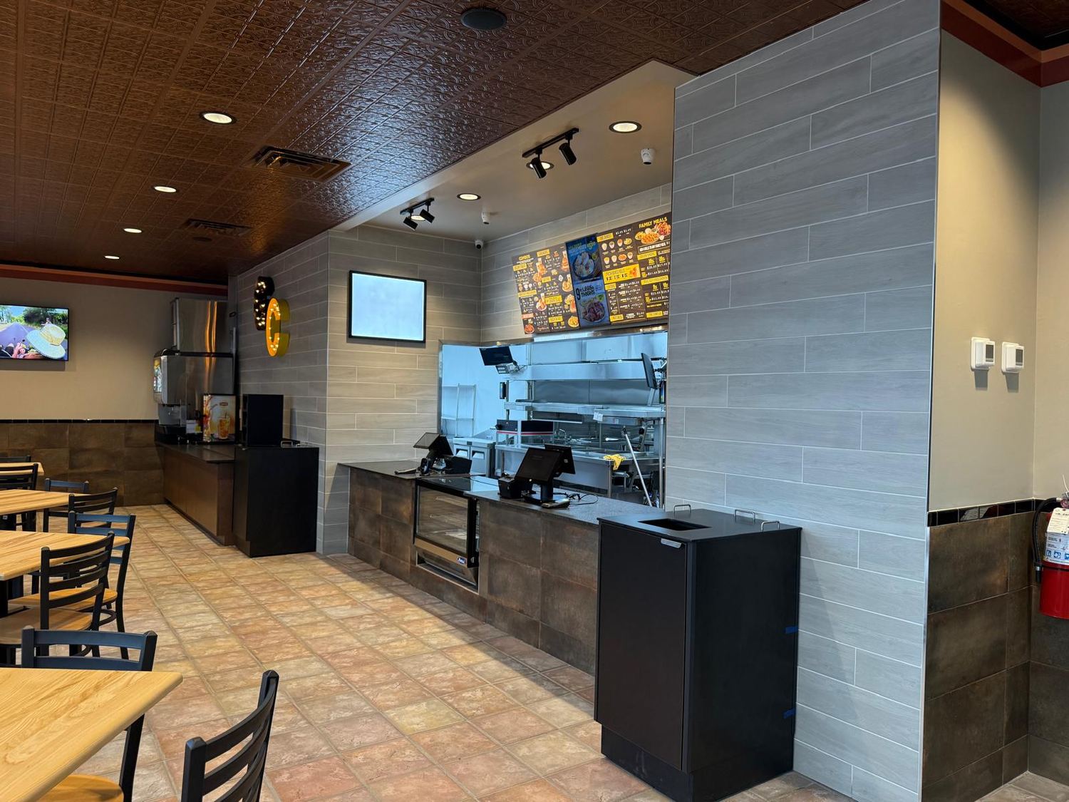 Finished order counter with pressed tin ceiling, menu boards and tiled surfaces
